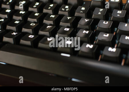Mechanical gaming keyboard close up letters, white backlit Stock Photo
