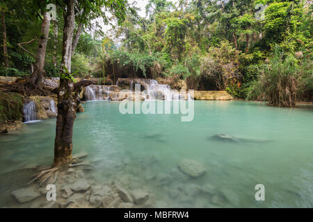 Beautiful view of small cascades and a shallow pool at the Tat Kuang Si Waterfalls near Luang Prabang in Laos. Stock Photo