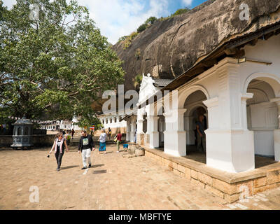 Horizontal view of tourists at the Dambulla Cave Temple in Sri Lanka. Stock Photo
