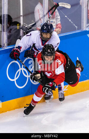 Shannon Sigrist (SUI) #9 and Danelle Im (KOR) #7 during Korea (combinded) vs Switzerland Women's Ice Hockey competition at the Olympic Winter Games Py Stock Photo