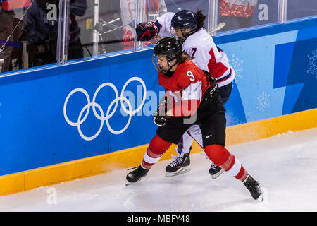 Shannon Sigrist (SUI) #9 and Danelle Im (KOR) #7 during Korea (combinded) vs Switzerland Women's Ice Hockey competition at the Olympic Winter Games Py Stock Photo