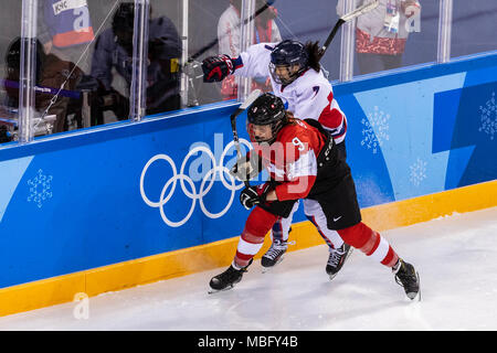 Shannon Sigrist (SUI) #9 and Danelle Im (KOR) #7 during Korea (combinded) vs Switzerland Women's Ice Hockey competition at the Olympic Winter Games Py Stock Photo