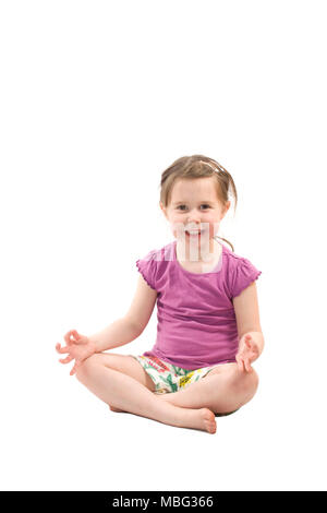 Young girl sitting in the lotus position on white background Stock Photo