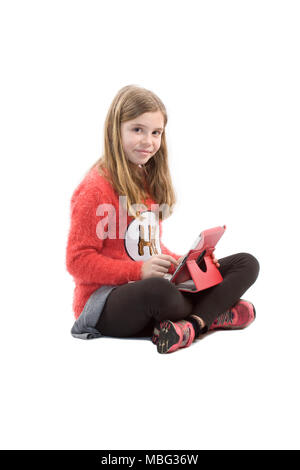 Young girl sat with iPad looking at camera Stock Photo