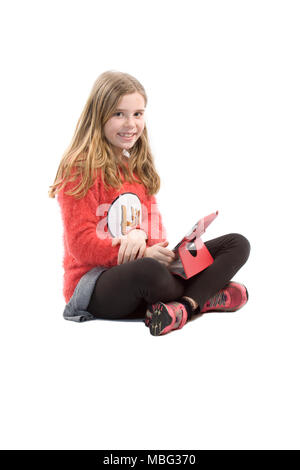 Young girl sat on floor using the iPad Stock Photo