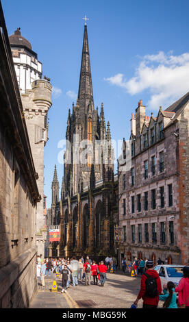 EDINBURGH, UK - AUG 9, 2012: Tourists at Royal Mile, a popular tourist attraction and the busiest tourist street in the Old Town. St. Giles Cathedral  Stock Photo