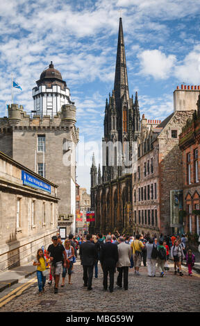 EDINBURGH, UK - AUG 9, 2012: Tourists at Royal Mile, a popular tourist attraction and the busiest tourist street in the Old Town. St. Giles Cathedral  Stock Photo