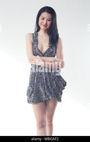 beautiful asian woman short dress white studio background Stock