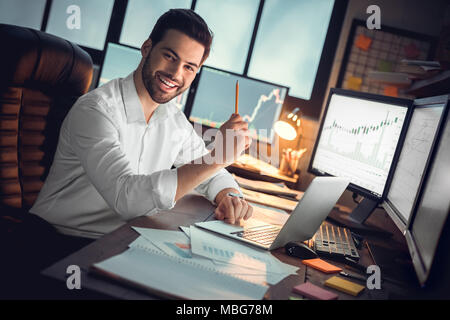 Portrait of happy motivated trader excited by new business idea, successful businessman or young cryptocurrency investor looking at camera working wit