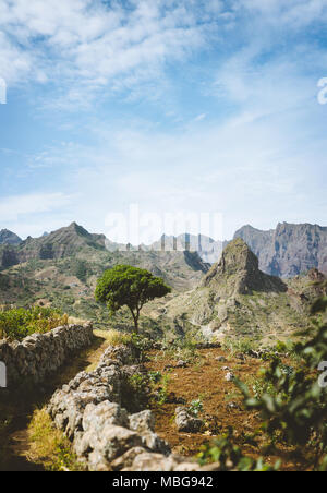 Hiking trail leading through arid rocky terrain towards Coculli village on Santo Antao Cape Verde Stock Photo