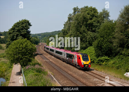 A Virgin Trains voyager train at Overdale, Lostock (north of Bolton)  with a train diverted from the west coast main line due to engineering work Stock Photo