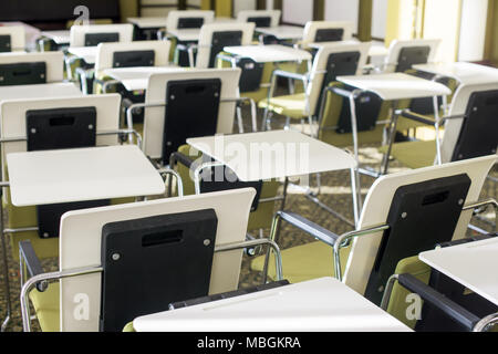 Big empty classroom wit lot of desks and chairs Stock Photo