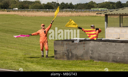 Flag marshals in action on Post 11 at Castle Combe Circuit, Wiltshire, UK Stock Photo