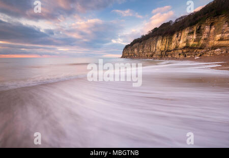 The Fairlight Cliffs at sunrise on Pett Level beach near Hastings, East Sussex Stock Photo