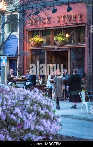 People enjoying a spring evening outside the Brick Store Pub at Decatur Square in downtown Decatur, Georgia. (USA) Stock Photo