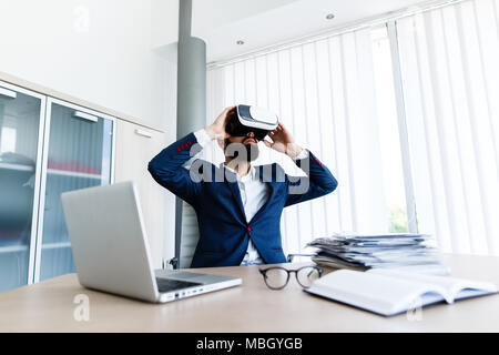 Young Businessman Using VR At Workplace Stock Photo