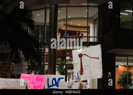 People in Orlando City Hall watch Anti-Trump Peaceful Protest in Downtown Orlando (2016). Stock Photo