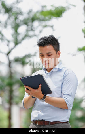 Young Japanese businessman downtown Tokyo Stock Photo