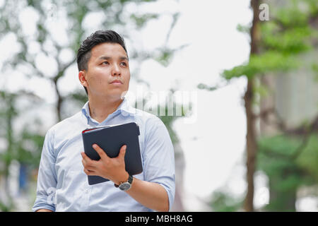 Young Japanese businessman downtown Tokyo Stock Photo