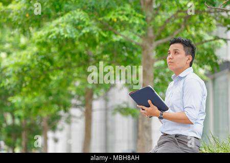 Young Japanese businessman downtown Tokyo Stock Photo