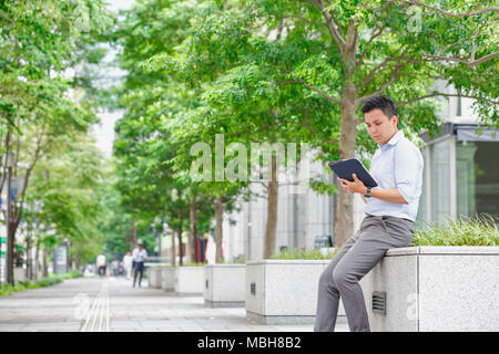 Young Japanese businessman downtown Tokyo Stock Photo