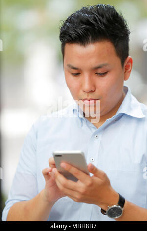 Young Japanese businessman downtown Tokyo Stock Photo