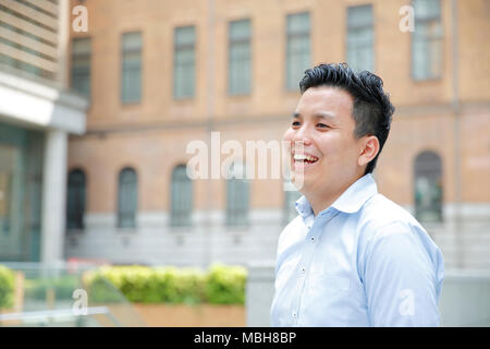 Young Japanese businessman downtown Tokyo Stock Photo