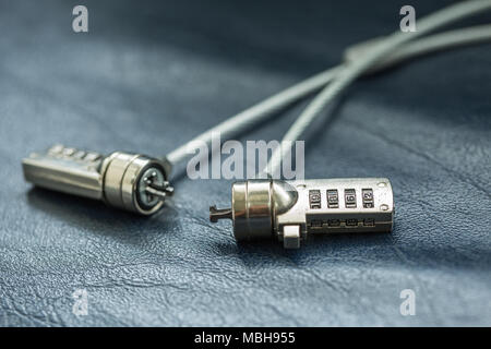 Two computer cable lock on black leather, Security concept shot for the digital age Stock Photo