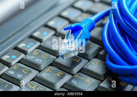 Macro of internet cable on keyboard of computer Stock Photo