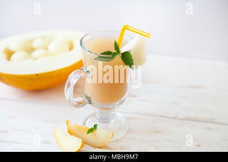 Healthy smoothie vitamins drink with  mint and cantaloupe melon,  on wooden rustic background, summer harvest beverage, diet concept Stock Photo