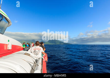 TAHITI, FRENCH POLYNESIA - APRIL 17, 2018: The tourists standing on a big ferry ship between Moorea Island and a large seaport in Tahiti Stock Photo