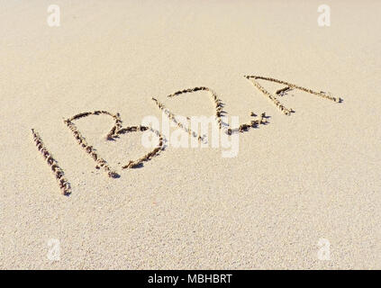 Ibiza text, drawing in the sand. Travel destination, beach holidays on Ibiza Island. Stock Photo