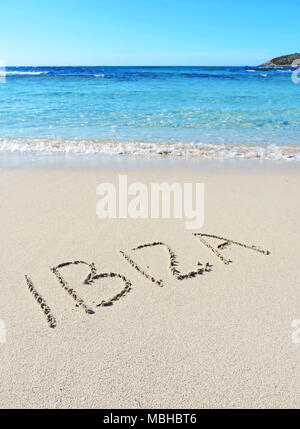 Ibiza text, drawing in the sand. Travel destination, beach holidays on Ibiza Island. Stock Photo