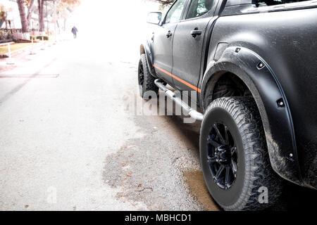 Bottom view to big offroad car wheel on country road and mountains  backdrop. Motion the wheels tires and off-road that goes in the dust on the  sand. Stock Photo by ©Tverdohlib.com 361887494