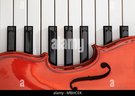 classical violin on white and black piano keys close-up background Stock Photo