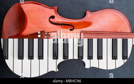 piano keys in to the violin on the black leather table, half keyboard like violin shape Stock Photo