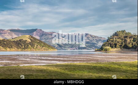 Scenic View of Akaroa Harbour at low tide. Akaroa Harbour is part of the  Banks Peninsula in the Canterbury Region of New Zealand. Stock Photo