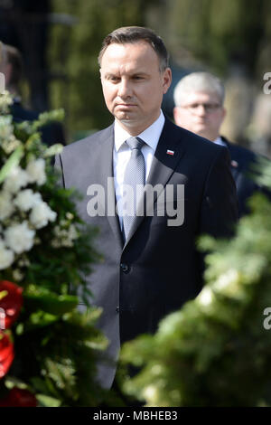 Warsaw, Poland. 10th Apr, 2018. Polish President Andrzej Duda (Front) attends the ceremony marking the eighth anniversary of the plane crash in Smolensk of Russia at the Powazki Military Cemetery in Warsaw, Poland, on April 10, 2018. Poland marked on Tuesday the eighth anniversary of the plane crash in Smolensk of Russia in which 96 Polish people, including the then-Polish President Lech Kaczynski, were killed. Credit: Jaap Arriens/Xinhua/Alamy Live News Stock Photo