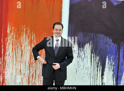 Frankfurt Main, Germany. 22nd Feb, 2012. Max Hollein, director of the Staedel, stands in front of 'Painting Action - Red' and 'Painting Action - Violet' by Hermann Nitsch in the newly opened Staedel expansion building in Frankfurt Main, Germany, 22 February 2012. The underground building houses the collection of contemporary art and costed around 52 million euros. The spectacular architectural building, which took more than two years to build, is characterized by 195 glass portals that let daylight into the eight meter high rooms. Credit: BORIS ROESSLER | usage worldwide/dpa/Alamy Live News Stock Photo