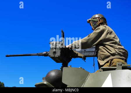 American soldier firing the turret machine gun on a Sherman Tank Stock Photo