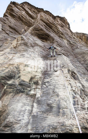 Climber doing a route in the rock Stock Photo