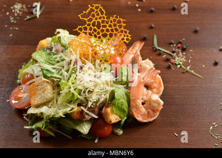 Close up to caesar salad bowl. Healthy salad bowl with tomatoes, Beacon, on wooden background top view. Food and health Stock Photo