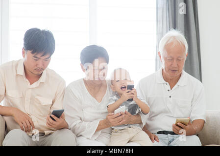 Technology devices, gadgets addicted family. Member family busy with their smart phone, communication problem. Stock Photo