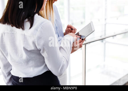 Arms of two womens typing on laptop in business modern interior Stock Photo