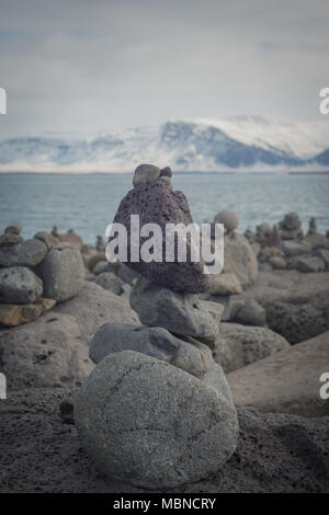 Stack of Balanced Igneous Lava Rocks by the Sea Shore in Iceland Stock Photo