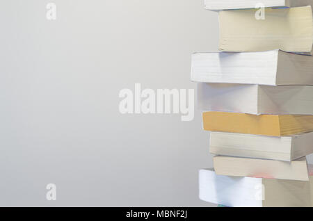 Pile of books on the right side and with light grey background Stock Photo