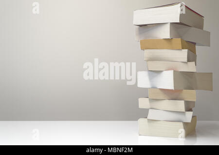 Pile of books on the table and with light grey background Stock Photo