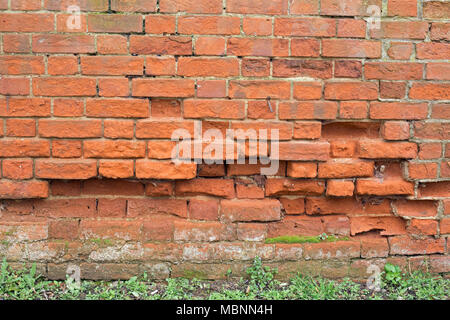 Crumbling red brick wall texture background Stock Photo