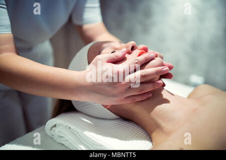 Relaxing anti stress facial massage Stock Photo