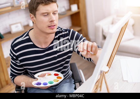 Attentive painter being deep in thoughts Stock Photo